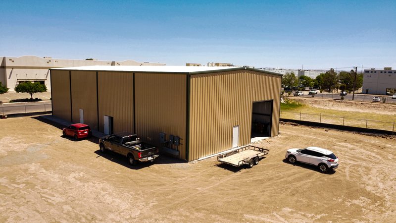 Finished metal commercial building with roll-up door, aerial view