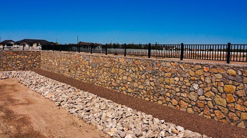 Stone rock wall with iron fence built by ARM